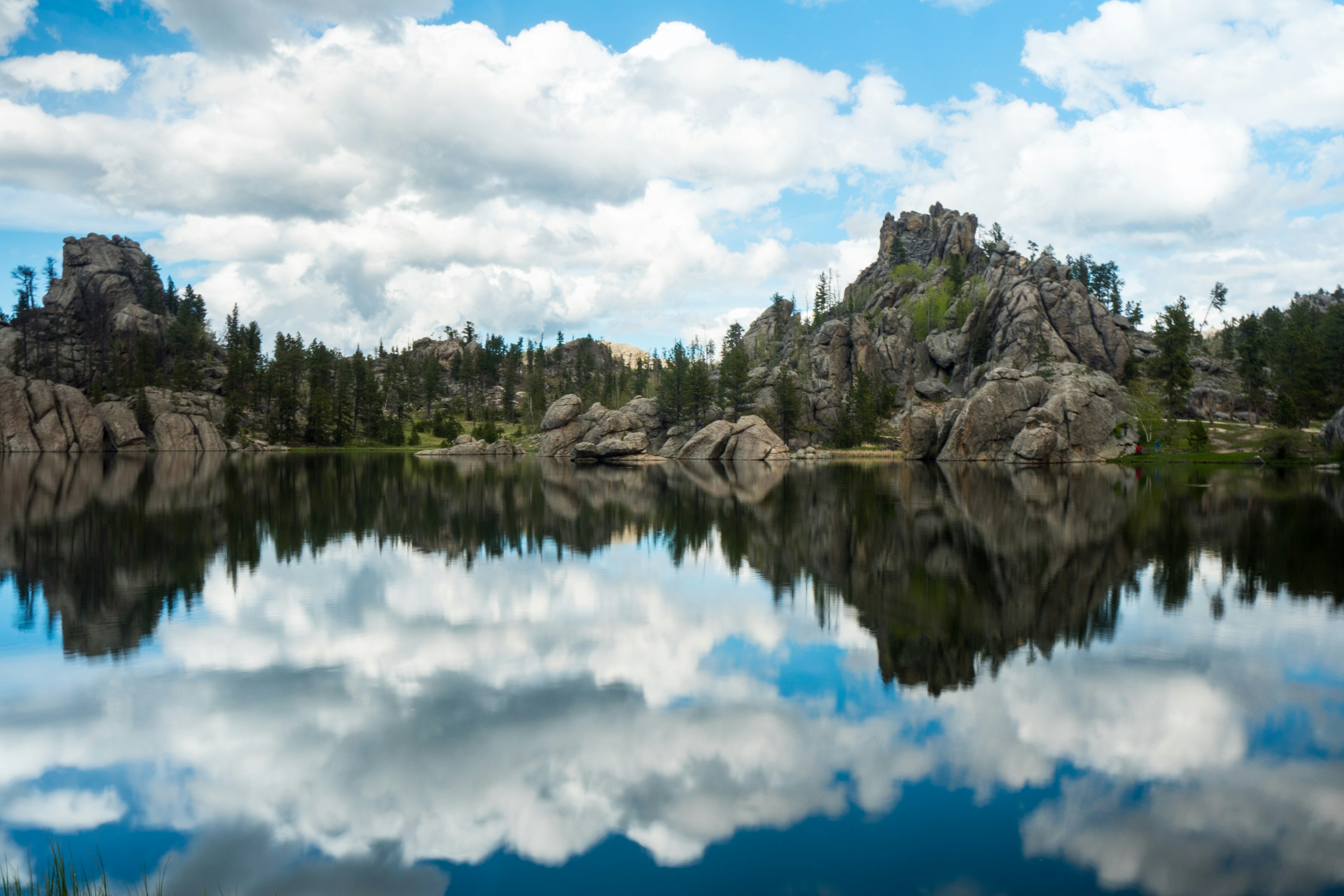 photography of body of water near mountain at daytime